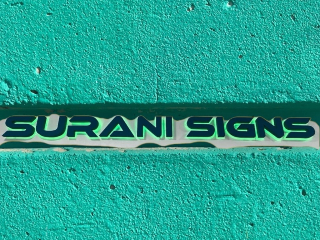 Custom dimensional sign on textured teal wall